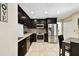 Stylish kitchen with stainless steel appliances, dark cabinetry, and granite countertops at 4161 Rolling Springs Dr, Tampa, FL 33624