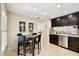 Eat-in kitchen with tile floors, stainless appliances, and dark cabinetry at 4161 Rolling Springs Dr, Tampa, FL 33624