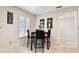 Breakfast nook featuring tile floors, a square table, and four chairs near a window with plantation shutters at 4161 Rolling Springs Dr, Tampa, FL 33624
