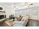 Spacious living room with fireplace, wood floors, neutral colors, and an abundance of natural light at 4161 Rolling Springs Dr, Tampa, FL 33624