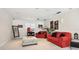 Living room with red couches and Coca-Cola decorations at 4161 Rolling Springs Dr, Tampa, FL 33624