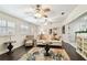 Inviting living room with hardwood floors, neutral furniture, and view into the dining room at 4161 Rolling Springs Dr, Tampa, FL 33624