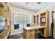 Functional home office features built-in desk, cabinets, shelving, and natural light at 4161 Rolling Springs Dr, Tampa, FL 33624