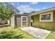 A storage shed sits on a concrete slab just outside the house wall with a door at 4161 Rolling Springs Dr, Tampa, FL 33624