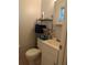 Cozy half bath with a pedestal sink and convenient shelving for storage at 4581 Deltona Blvd, Spring Hill, FL 34606