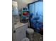 Cozy bathroom with a classic design, featuring a vanity, toilet, and shower with a dolphin-themed curtain at 4581 Deltona Blvd, Spring Hill, FL 34606