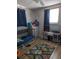 Charming bedroom featuring a crib, play kitchen, and hardwood floors at 4581 Deltona Blvd, Spring Hill, FL 34606