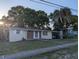Charming single-story home with a cozy front porch, attached carport, and mature trees at 4581 Deltona Blvd, Spring Hill, FL 34606