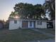Attractive single-story home with carport, mature landscaping, and brick detailing at 4581 Deltona Blvd, Spring Hill, FL 34606
