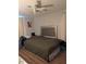 Comfortable main bedroom with a large bed, ceiling fan, and natural light at 4581 Deltona Blvd, Spring Hill, FL 34606