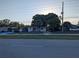 A quiet residential street view showcases several single-story homes and mature trees at 4581 Deltona Blvd, Spring Hill, FL 34606