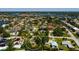 Aerial view of a residential area near the water featuring homes with well-maintained lawns and mature trees at 459 Bayview Ne Dr, St Petersburg, FL 33704