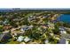 Neighborhood aerial view showcasing lush landscaping and waterfront homes, with a distant cityscape backdrop at 459 Bayview Ne Dr, St Petersburg, FL 33704