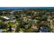 An aerial view showcasing a quiet residential neighborhood surrounded by lush trees near the waterfront at 459 Bayview Ne Dr, St Petersburg, FL 33704