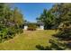 Spacious backyard with well-maintained lawn and mature trees, providing privacy at 459 Bayview Ne Dr, St Petersburg, FL 33704