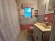 Retro bathroom featuring pink and gray tiles, a vanity, and a shower with a unique seashell pattern curtain at 459 Bayview Ne Dr, St Petersburg, FL 33704