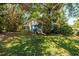 View of the home's backyard nestled in lush landscaping at 459 Bayview Ne Dr, St Petersburg, FL 33704