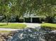 Charming single-story home with a well-manicured lawn and paver driveway at 459 Bayview Ne Dr, St Petersburg, FL 33704