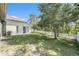 Private backyard featuring lush green lawn, white picket fence and mature trees at 4656 Copper Hill Dr, Spring Hill, FL 34609
