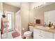This bathroom features a spacious vanity, neutral color palette, and an adjacent linen closet for towels and toiletries at 4656 Copper Hill Dr, Spring Hill, FL 34609