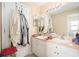 Functional bathroom featuring a double vanity, large mirror, neutral paint, and a convenient layout at 4656 Copper Hill Dr, Spring Hill, FL 34609