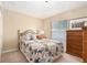 This bedroom features a spacious layout, plush carpet, and a large window for ample natural light at 4656 Copper Hill Dr, Spring Hill, FL 34609