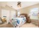 Cozy bedroom featuring ceiling fan, bright window, carpet flooring, and ample closet space at 4656 Copper Hill Dr, Spring Hill, FL 34609