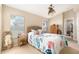 Charming bedroom featuring ceiling fan, bright window, carpet flooring, and wicker bed frame at 4656 Copper Hill Dr, Spring Hill, FL 34609
