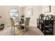 Dining area with ample natural light, a round glass table, and elegant seating at 4656 Copper Hill Dr, Spring Hill, FL 34609