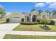 Charming home with a well-manicured lawn, lush landscaping, and a welcoming entrance at 4656 Copper Hill Dr, Spring Hill, FL 34609