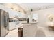 Bright kitchen featuring white cabinetry, granite countertops, and modern stainless steel appliances at 4656 Copper Hill Dr, Spring Hill, FL 34609