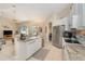 Bright, modern kitchen features granite countertops, tile floors, and open floor plan at 4656 Copper Hill Dr, Spring Hill, FL 34609