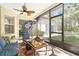 Enjoy the outdoors in the screened lanai with views of the private backyard, ceiling fan, and comfortable seating area at 4656 Copper Hill Dr, Spring Hill, FL 34609
