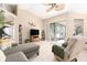 Spacious living area featuring vaulted ceilings, ceiling fan, and sliding glass doors to the outdoor patio at 4656 Copper Hill Dr, Spring Hill, FL 34609