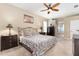 Comfortable bedroom featuring ceiling fan, large windows, neutral paint, carpet, and ample closet space at 4656 Copper Hill Dr, Spring Hill, FL 34609