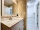 Bright bathroom featuring modern vanity, quartz countertop, and neutral tile, with access to closet at 4799 Coquina Key Se Dr, St Petersburg, FL 33705