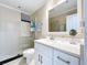 Bathroom with white cabinets, glass shower and modern fixtures at 4799 Coquina Key Se Dr, St Petersburg, FL 33705