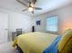 Bright bedroom featuring ceiling fan, closet, and desk with a white door at 4799 Coquina Key Se Dr, St Petersburg, FL 33705