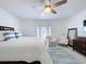 Well-lit bedroom with a ceiling fan, decor rug, comfortable furniture, and a door to the outside at 4799 Coquina Key Se Dr, St Petersburg, FL 33705
