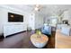 Inviting living room with a large TV and views into the kitchen at 4799 Coquina Key Se Dr, St Petersburg, FL 33705