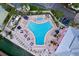 Aerial view of a large community pool with lounge chairs and umbrellas, offering a relaxing oasis at 4799 Coquina Key Se Dr, St Petersburg, FL 33705