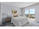Cozy bedroom with balcony overlooking waterfront, featuring neutral tones, and soft lighting at 4900 Brittany S Dr # 1414, St Petersburg, FL 33715