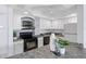 Cozy kitchen with white cabinets, black appliances, and modern countertops at 4900 Brittany S Dr # 1414, St Petersburg, FL 33715