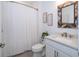 Bright bathroom featuring white cabinetry, a white chevron curtain and modern fixtures at 5597 Bay Tide Ct, Land O Lakes, FL 34638