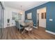 Bright dining room with contemporary lighting, stylish decor, and access to the patio at 5597 Bay Tide Ct, Land O Lakes, FL 34638