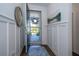 Welcoming entryway with wood floors and decorative wall panels that looks out to the front yard at 5597 Bay Tide Ct, Land O Lakes, FL 34638