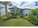 Inviting single-story home with a well-kept lawn, beautiful landscaping, and a welcoming front porch at 5597 Bay Tide Ct, Land O Lakes, FL 34638