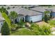 Charming single-story home featuring a manicured lawn, lush landscaping, and an attached two-car garage at 5597 Bay Tide Ct, Land O Lakes, FL 34638