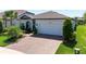 Charming single-story home with brick driveway, a two-car garage, and manicured front yard at 5597 Bay Tide Ct, Land O Lakes, FL 34638