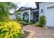 Inviting front entrance with brick pathway and meticulously maintained, colorful landscaping at 5597 Bay Tide Ct, Land O Lakes, FL 34638